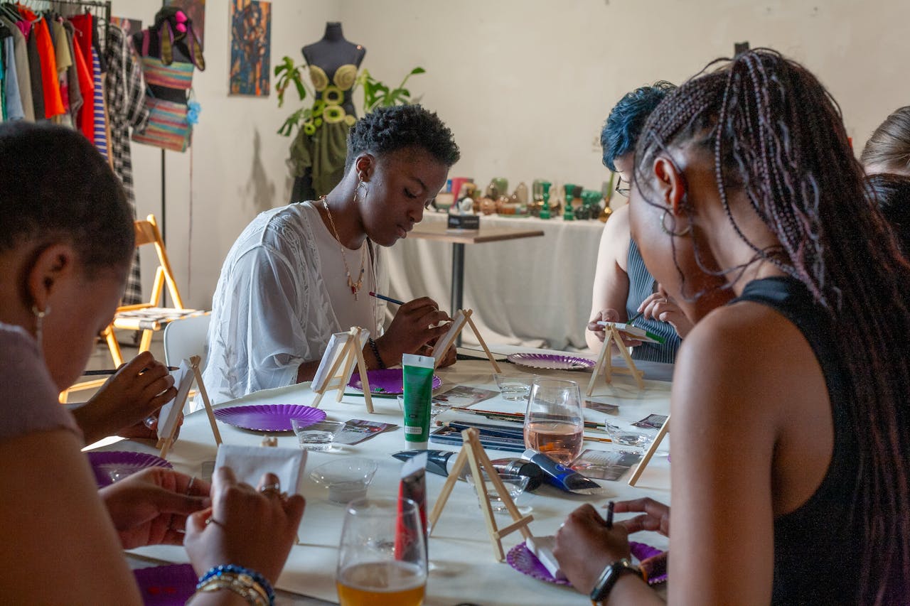 A diverse group at an art workshop engaging in acrylic painting activities.