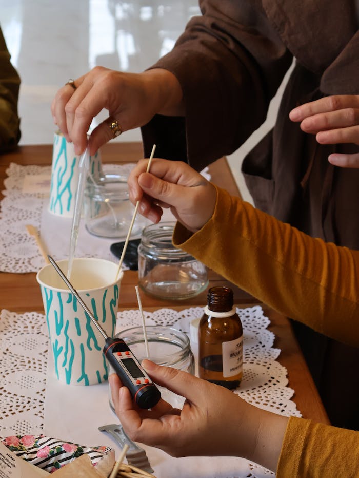 Hands-on candle making workshop showing participants crafting with materials.